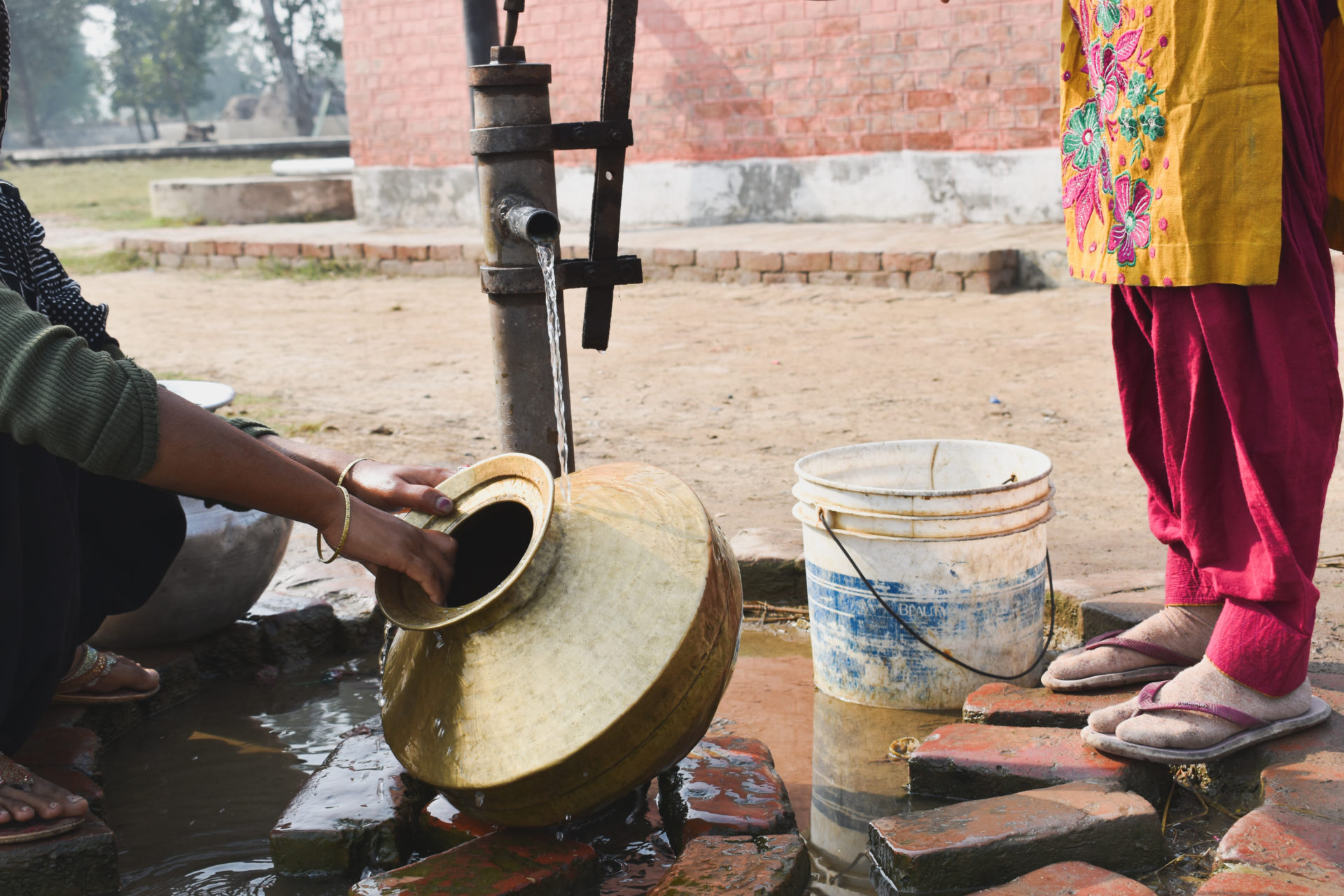 Low Section Of Women Taking Water From Tubewell In Village Area Of Haryana, India